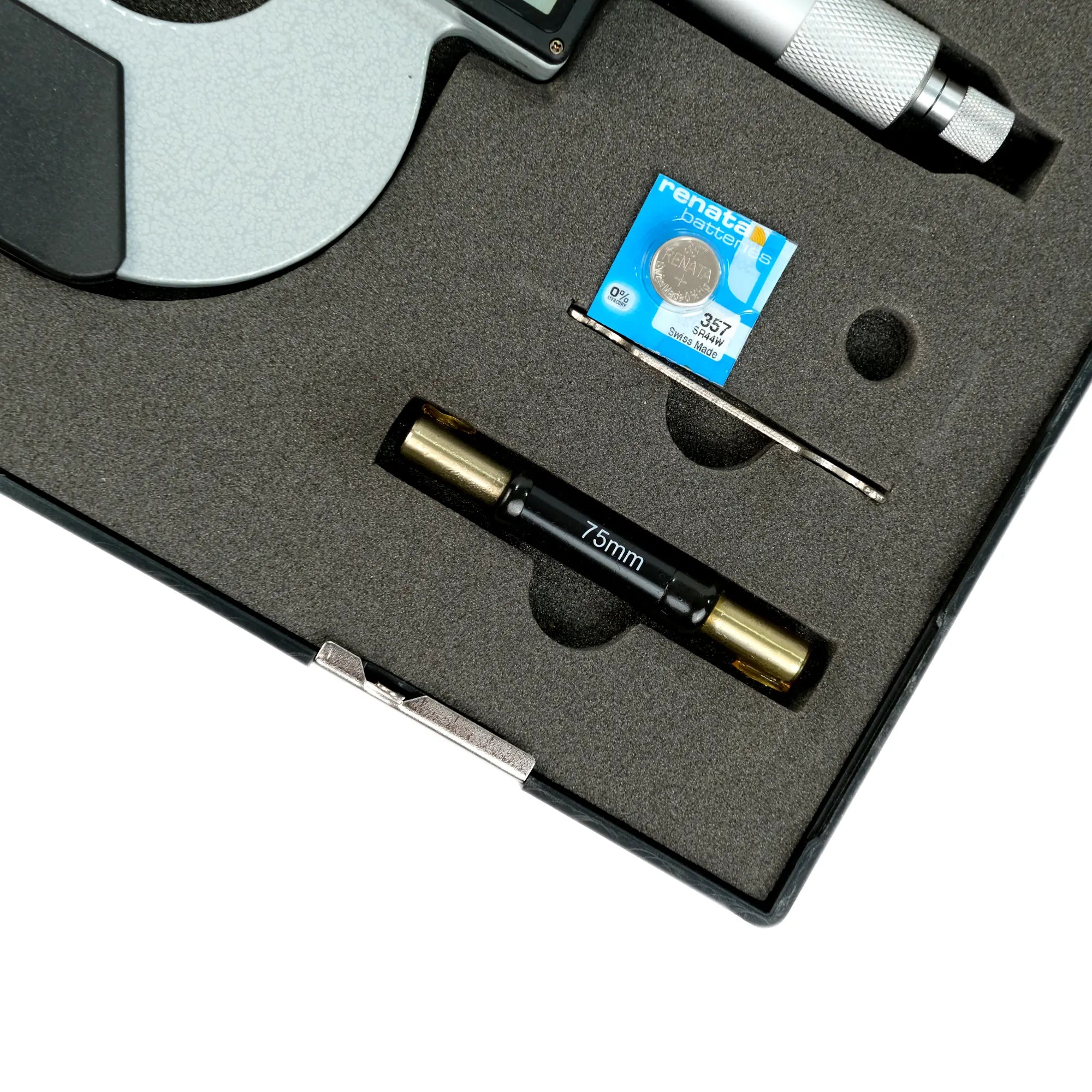 Precision tool set with a small blue card on a gray surface