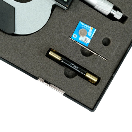 Precision tool set with a small blue card on a gray surface