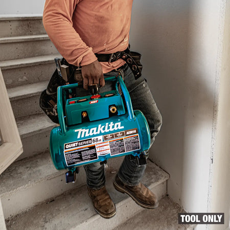 Person holding a Makita tool on a staircase