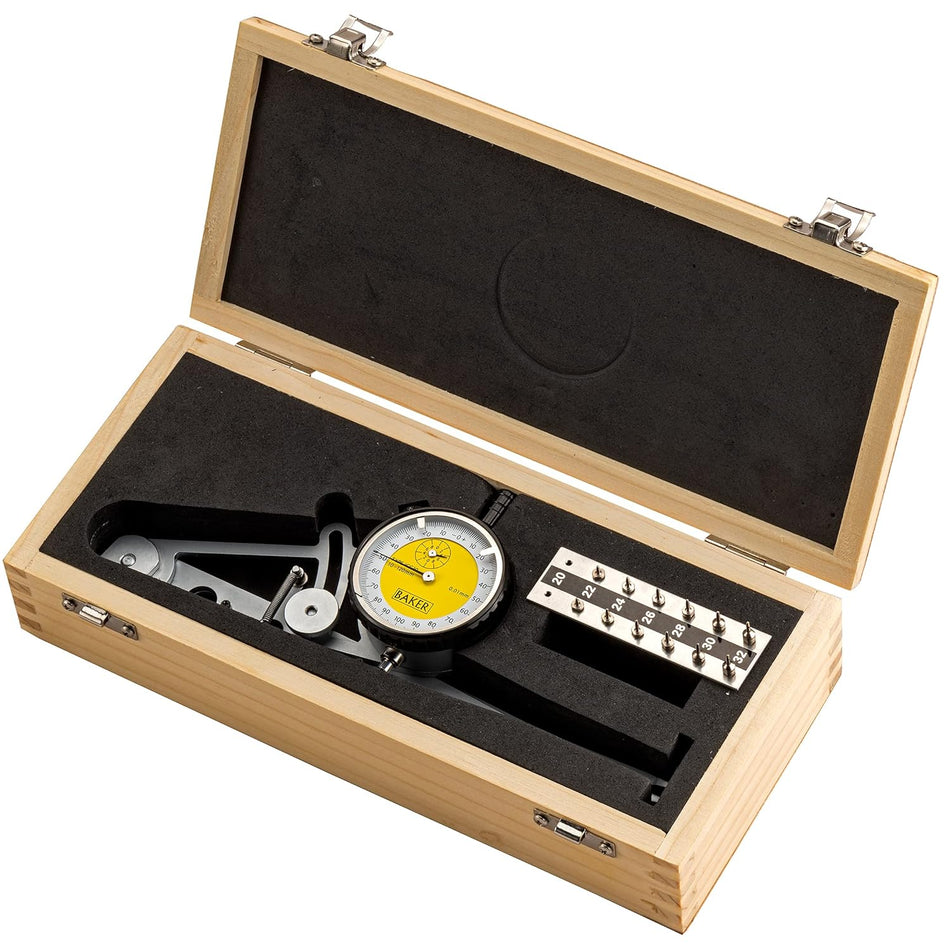 Dial indicator with accessories in a wooden case on a white background