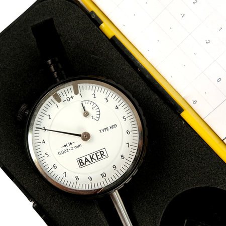 Baker dial indicator with a black case on a white background