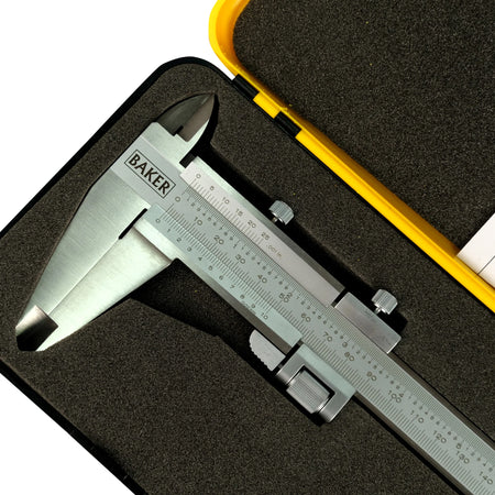Baker caliper on a black foam-lined tray with a yellow edge