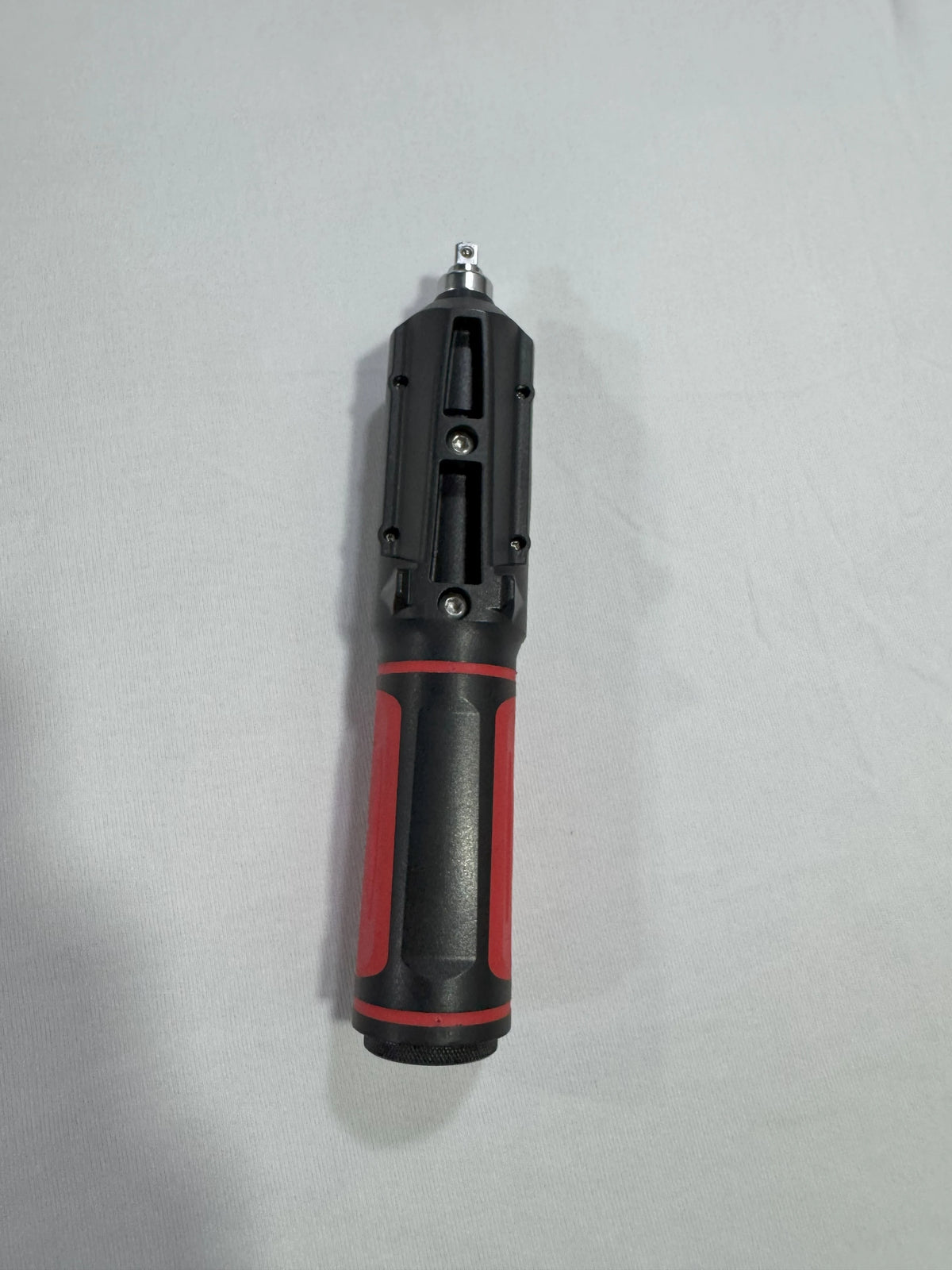 Black and red tool on a light gray background